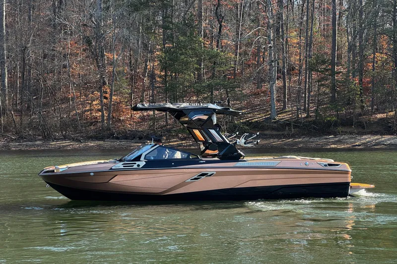 Slide: The Image of 2025 Centurion Ri265 boat cruising on a serene lake with autumn trees in the background. - 9