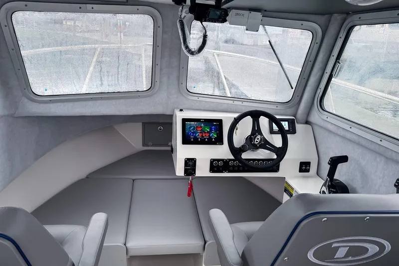 Slide: The Image of Manufacturer Provided Image: Interior of 2025 Defiance Admiral 220 EX boat with modern dashboard and steering wheel. - 2