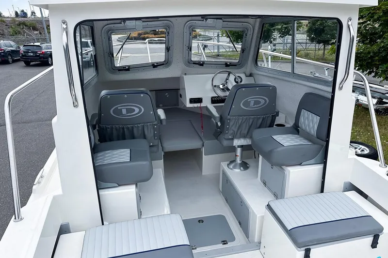 Slide: The Image of Manufacturer Provided Image: Interior of 2025 Defiance Admiral 220 EX boat, featuring seating and steering area. - 3