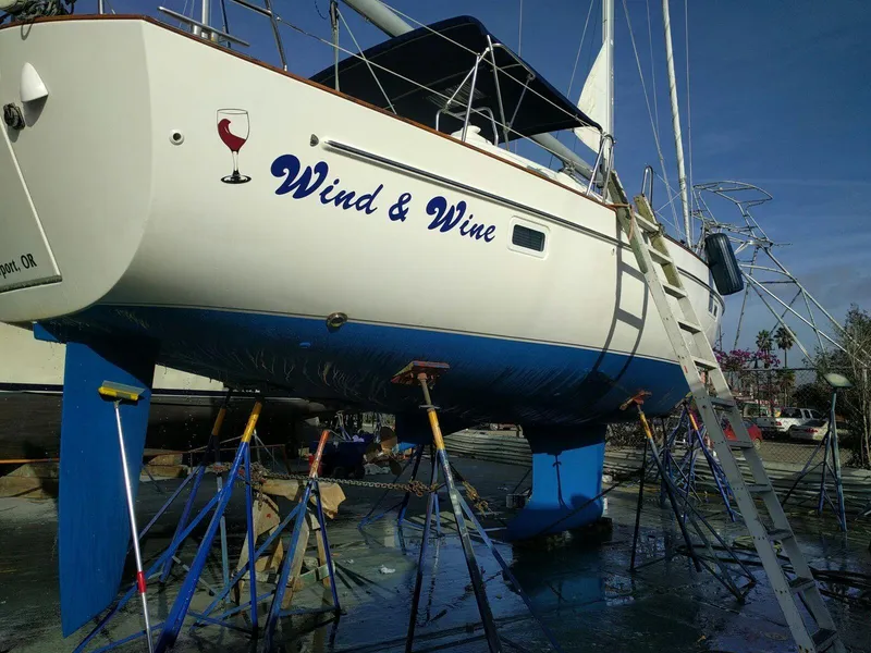 Slide: The Image of Beneteau Oceanis 42CC sailboat named 'Wind & Wine' on dry dock. - 12