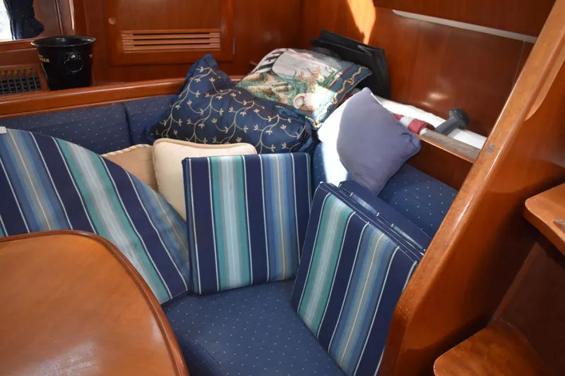 Slide: The Image of Interior of Beneteau Oceanis 42CC yacht, cozy seating area with cushions. - 27