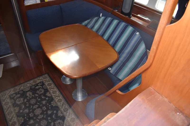 Slide: The Image of Interior of 2002 Beneteau Oceanis 42CC sailboat with wooden table. - 31