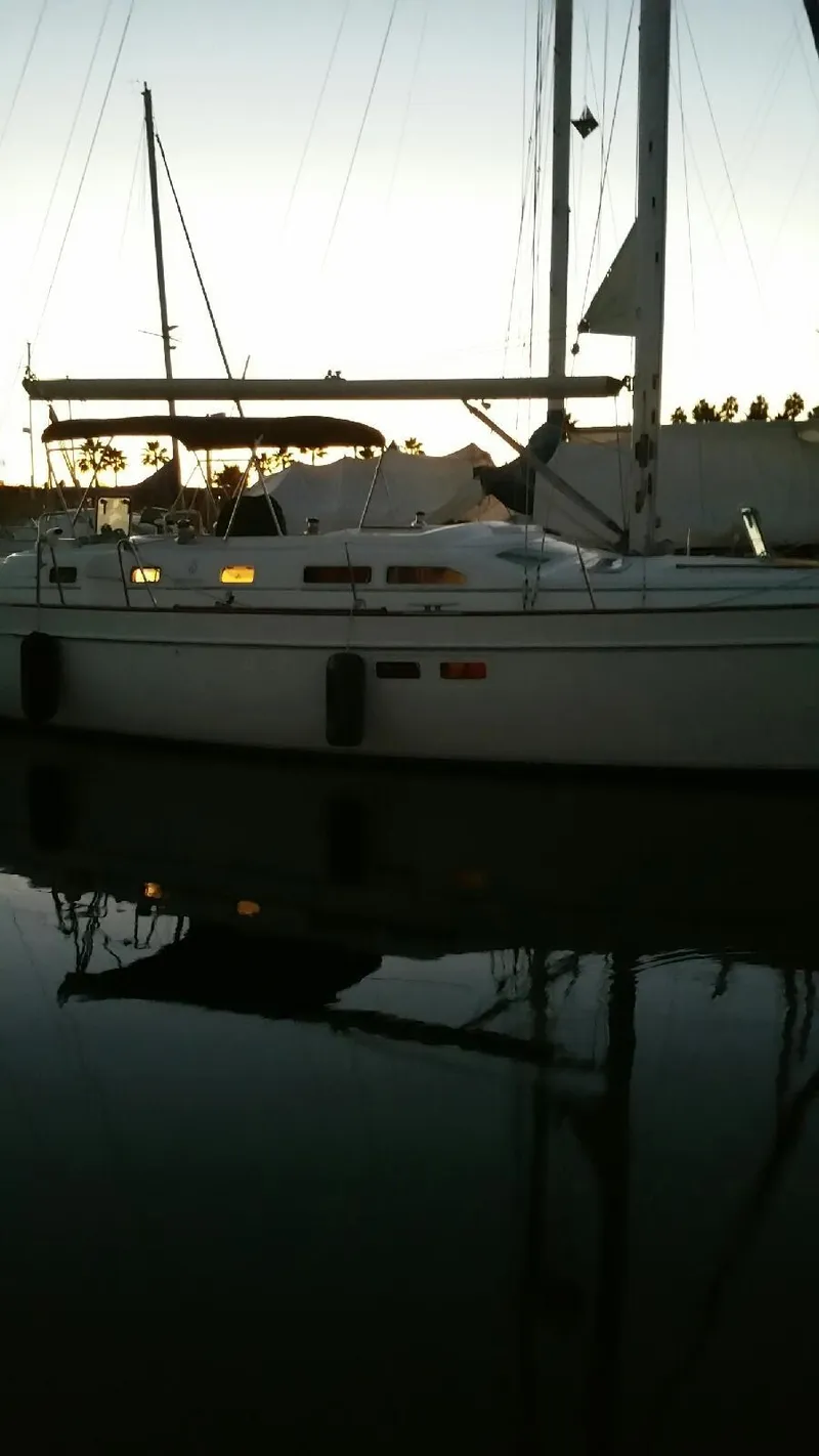 Slide: The Image of 2002 Beneteau Oceanis 42CC sailboat on calm water at sunset. - 9