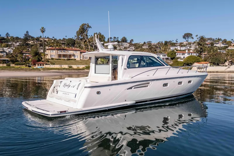 Slide: The Image of 2006 Tiara Yachts 5200 Sovran Salon cruising near scenic coastal homes. - 0