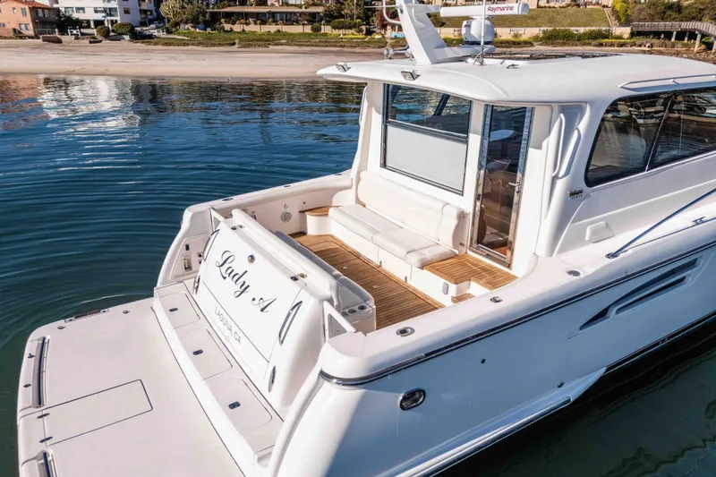 Slide: The Image of 2006 Tiara Yachts 5200 Sovran Salon, docked near a sandy beach. - 10