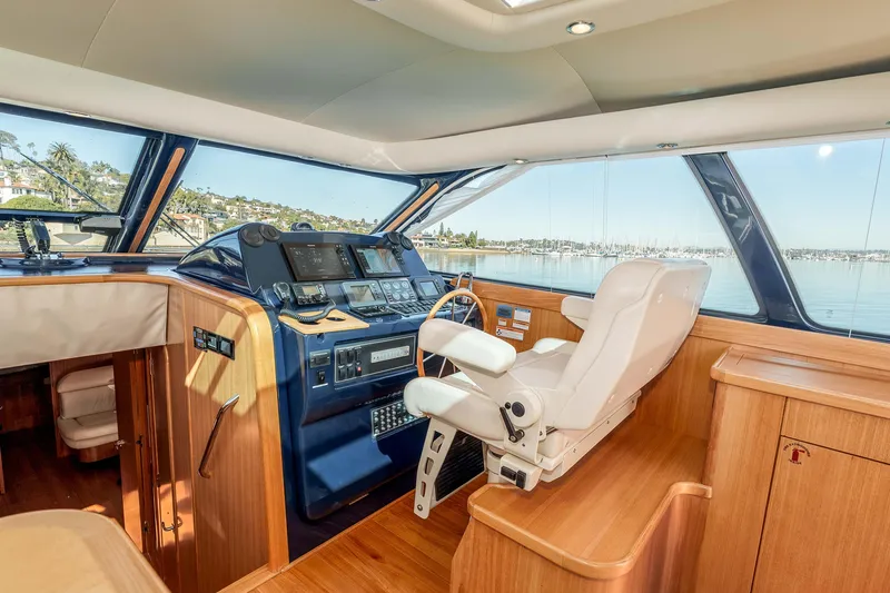 Slide: The Image of Luxurious 2006 Tiara Yachts 5200 Sovran Salon helm with panoramic views and elegant wood finish. - 15