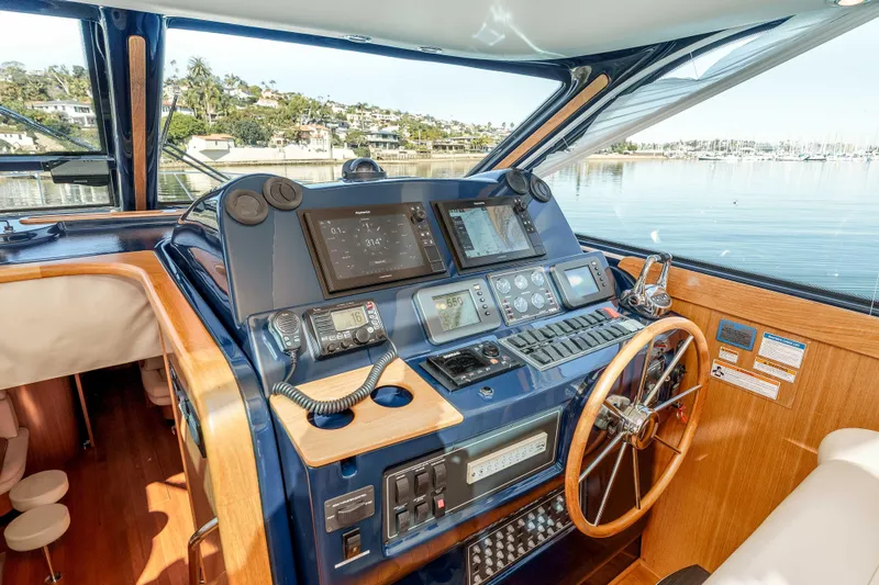 Slide: The Image of Helm of 2006 Tiara Yachts 5200 Sovran Salon with navigation equipment and wooden steering wheel. - 16