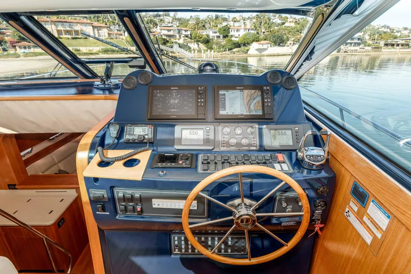 Slide: The Image of Helm of 2006 Tiara Yachts 5200 Sovran Salon with navigation equipment and wooden steering wheel. - 17