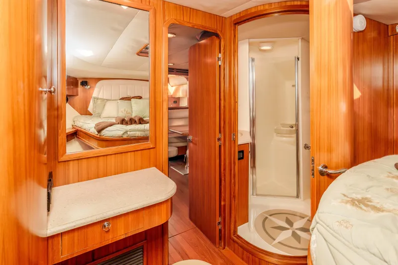Slide: The Image of Luxurious 2006 Tiara Yachts 5200 Sovran Salon interior with wood finish and cozy bedroom. - 26