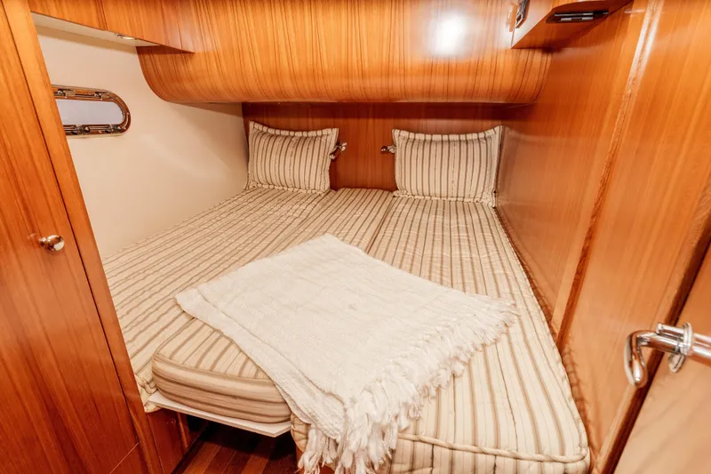 Slide: The Image of Luxurious cabin interior of 2006 Tiara Yachts 5200 Sovran Salon with striped bedding. - 29