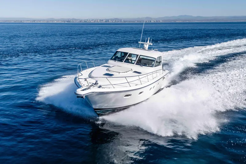Slide: The Image of 2006 Tiara Yachts 5200 Sovran Salon cruising on open water, creating a dynamic wake. - 3
