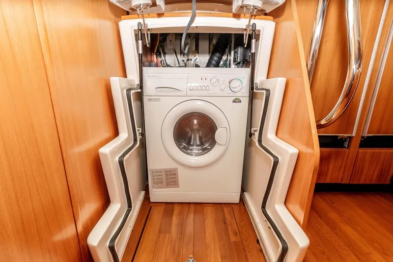 Slide: The Image of Washing machine in 2006 Tiara Yachts 5200 Sovran Salon, wooden interior, open cabinet. - 32