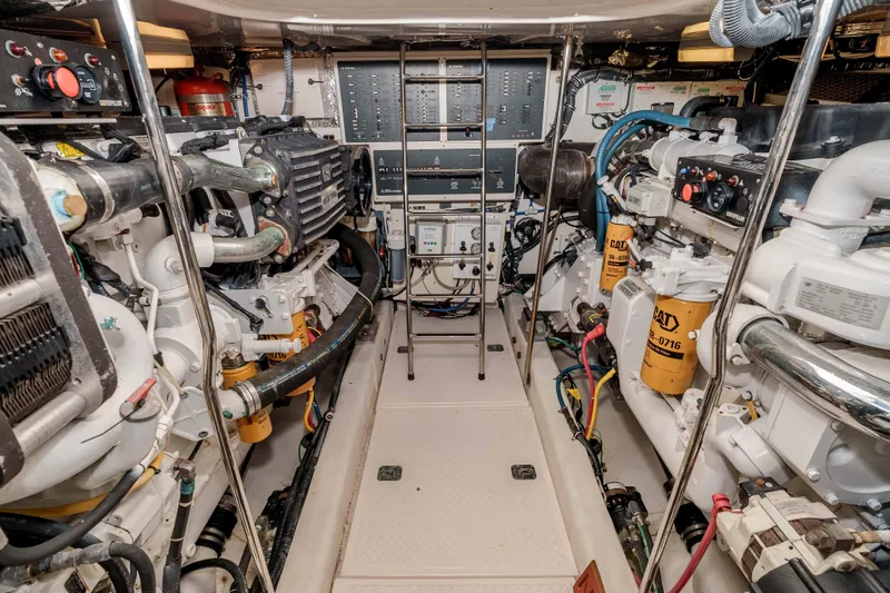 Slide: The Image of Engine room of 2006 Tiara Yachts 5200 Sovran Salon, featuring dual engines and control panels. - 33