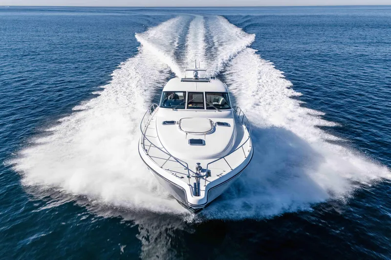 Slide: The Image of 2006 Tiara Yachts 5200 Sovran Salon cruising on open water, creating a dynamic wake. - 4