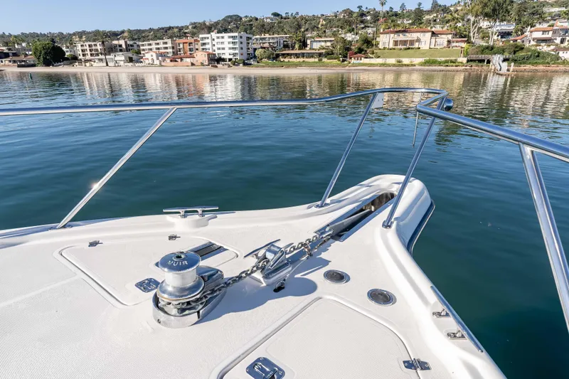Slide: The Image of Bow of 2006 Tiara Yachts 5200 Sovran Salon overlooking calm waters and coastal buildings. - 40