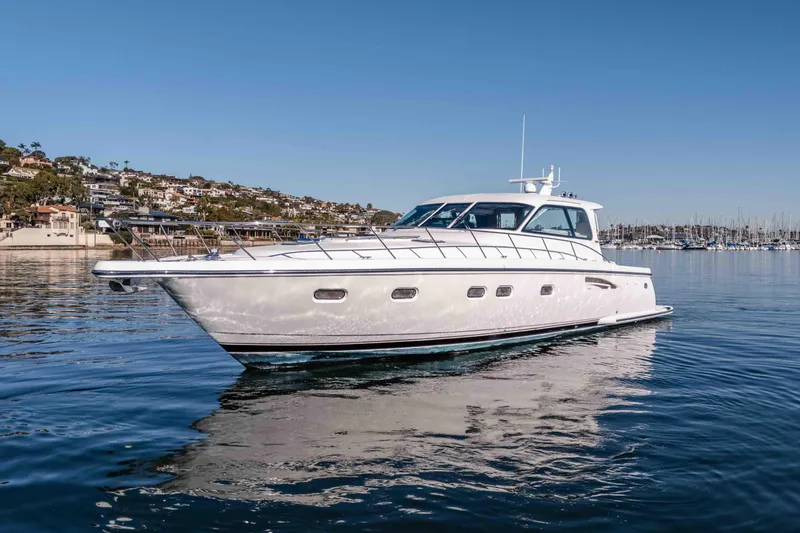 Slide: The Image of 2006 Tiara Yachts 5200 Sovran Salon cruising on calm waters near a coastal town. - 7