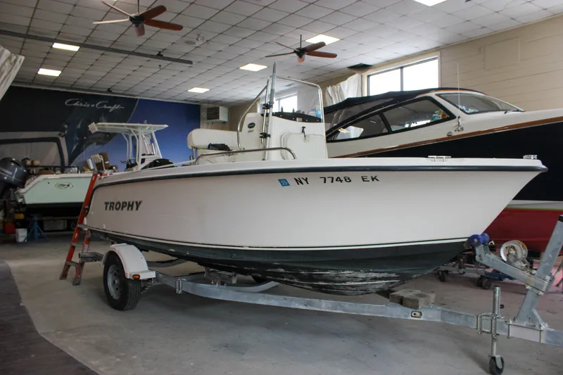 Slide: The Image of 2003 Trophy 1903 Center Console boat on trailer in indoor storage. - 0