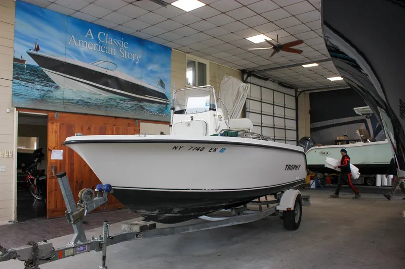 Slide: The Image of 2003 Trophy 1903 Center Console boat in showroom with classic American story banner. - 1