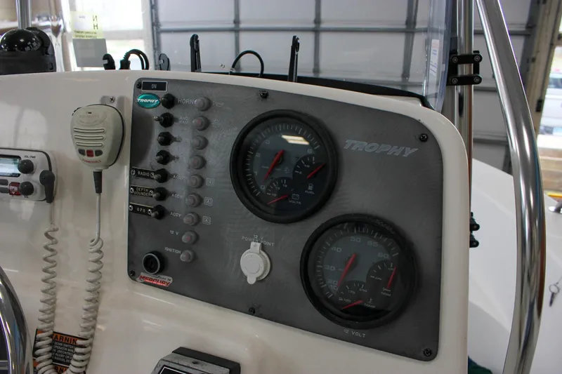 Slide: The Image of 2003 Trophy 1903 Center Console dashboard with gauges and controls in a garage setting. - 13