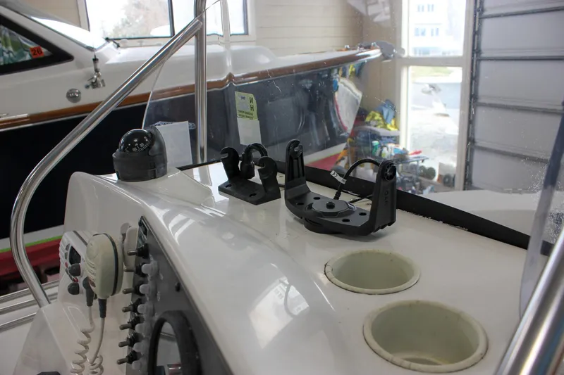 Slide: The Image of 2003 Trophy 1903 Center Console boat dashboard with navigation equipment and cup holders. - 14