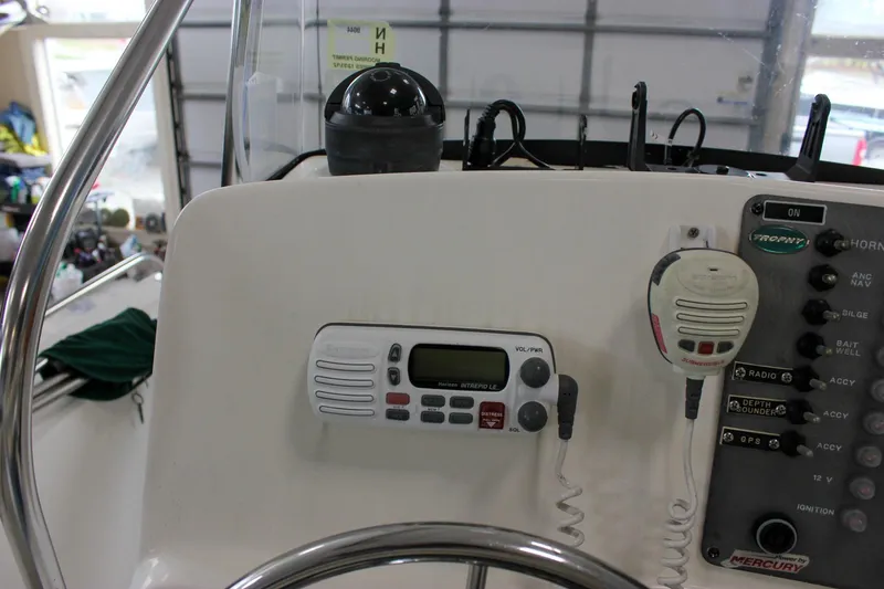 Slide: The Image of 2003 Trophy 1903 Center Console boat dashboard with radio and control panel. - 15