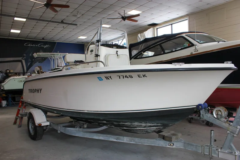 Slide: The Image of 2003 Trophy 1903 Center Console boat on trailer in indoor storage. - 2