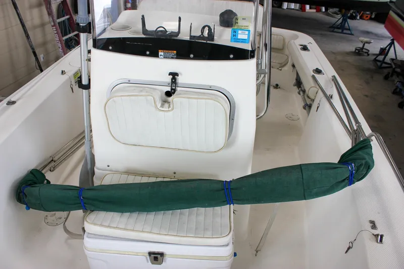 Slide: The Image of 2003 Trophy 1903 Center Console boat interior with seating and green cover. - 25