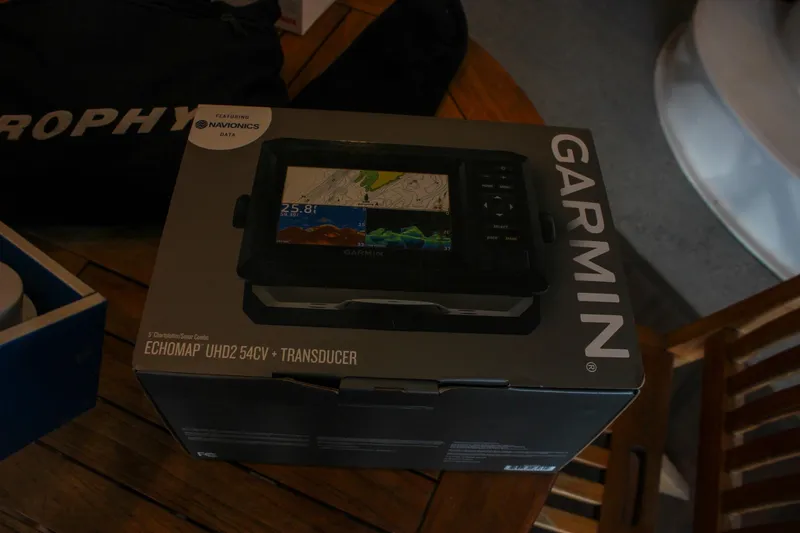 Slide: The Image of Box of Garmin ECHOMAP UHD2 54cv with transducer on wooden table. - 29