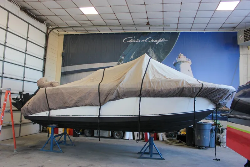 Slide: The Image of 2003 Trophy 1903 Center Console boat covered in storage, indoor garage setting. - 32