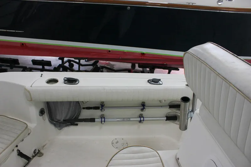 Slide: The Image of 2003 Trophy 1903 Center Console boat interior with white seating and storage compartments. - 8