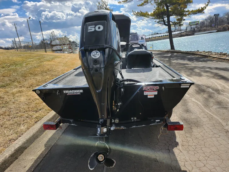 Slide: The Image of 2021 Tracker Bass Tracker Classic XL boat with 50 HP motor by a lake. - 2