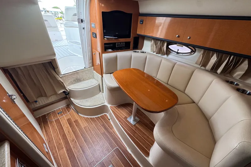 Slide: The Image of Interior of 2009 Chaparral Signature 290 yacht with cozy seating and wooden table. - 10