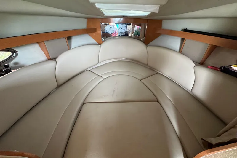 Slide: The Image of 2009 Chaparral Signature 290 cabin interior with beige seating and wooden accents. - 11