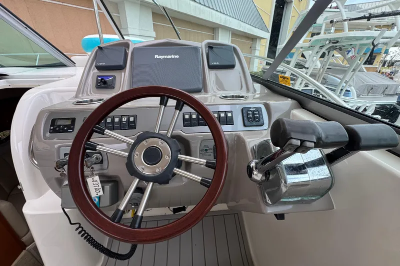 Slide: The Image of 2009 Chaparral Signature 290 helm with Raymarine electronics and wooden steering wheel. - 18