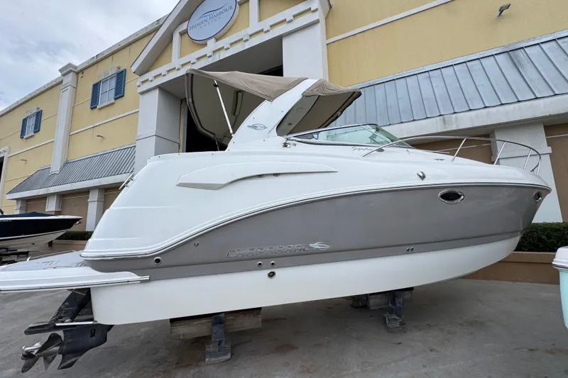Slide: The Image of 2009 Chaparral Signature 290 boat displayed outside a building. - 2