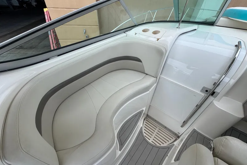 Slide: The Image of 2009 Chaparral Signature 290 boat interior with white seating and sleek design. - 21