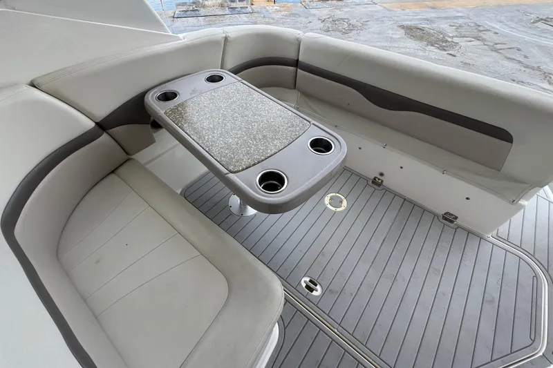 Slide: The Image of 2009 Chaparral Signature 290 boat interior with seating and table, featuring cup holders. - 23