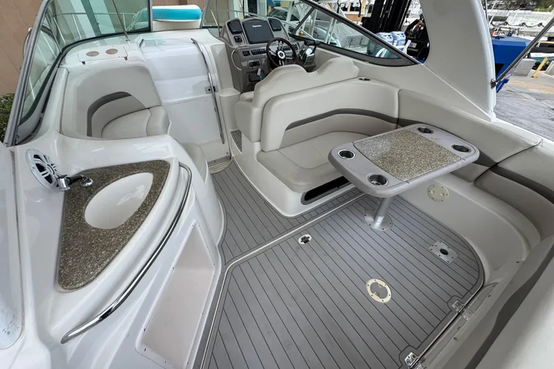 Slide: The Image of 2009 Chaparral Signature 290 boat interior with seating, table, and sink. - 24