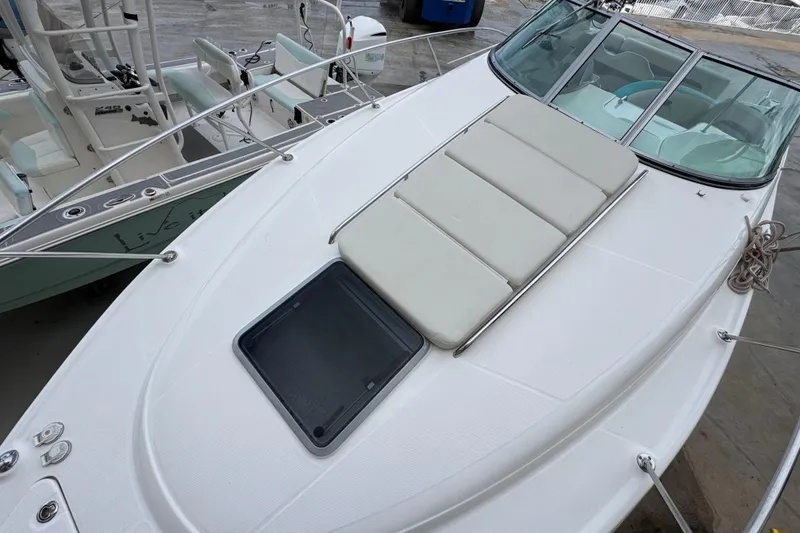 Slide: The Image of 2009 Chaparral Signature 290 boat with cushioned deck and windshield, docked at marina. - 25