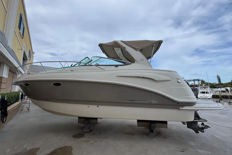 Slide: The Image of 2009 Chaparral Signature 290 boat on dry dock, side view with canopy. - 3