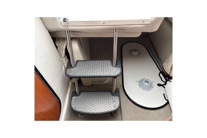 Slide: The Image of Interior steps of a 2001 Crownline 242 CR boat, featuring metal and rubber treads. - 15