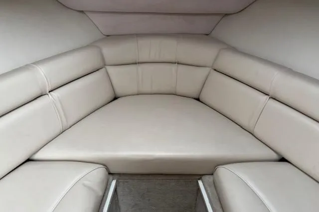Slide: The Image of 2001 Crownline 242 CR boat interior with beige cushioned seating. - 17