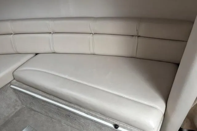 Slide: The Image of 2001 Crownline 242 CR boat interior with beige leather seating. - 18