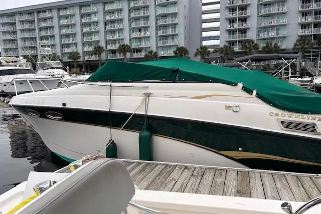 Slide: The Image of 2001 Crownline 242 CR boat docked at marina with green cover. - 20