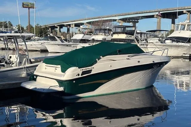 Slide: The Image of 2001 Crownline 242 CR boat docked in marina with green cover. - 21