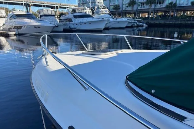 Slide: The Image of 2001 Crownline 242 CR boat docked in marina with other yachts. - 22
