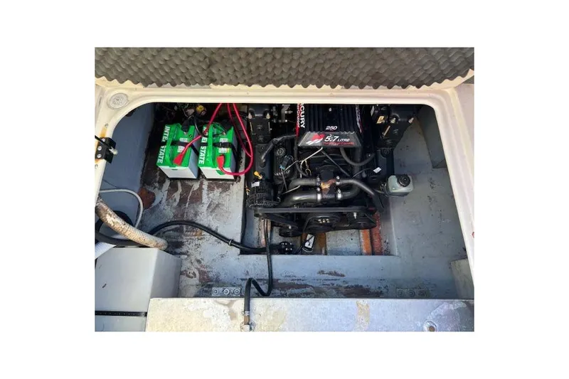 Slide: The Image of Engine compartment of 2001 Crownline 242 CR boat with batteries and Mercury engine. - 23