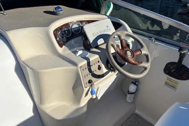Slide: The Image of 2001 Crownline 242 CR boat dashboard with Garmin GPS and steering wheel. - 24