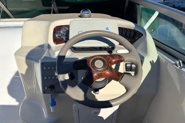 Slide: The Image of Steering wheel and dashboard of 2001 Crownline 242 CR boat. - 26