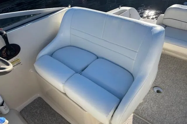 Slide: The Image of 2001 Crownline 242 CR boat interior with white cushioned seating. - 27